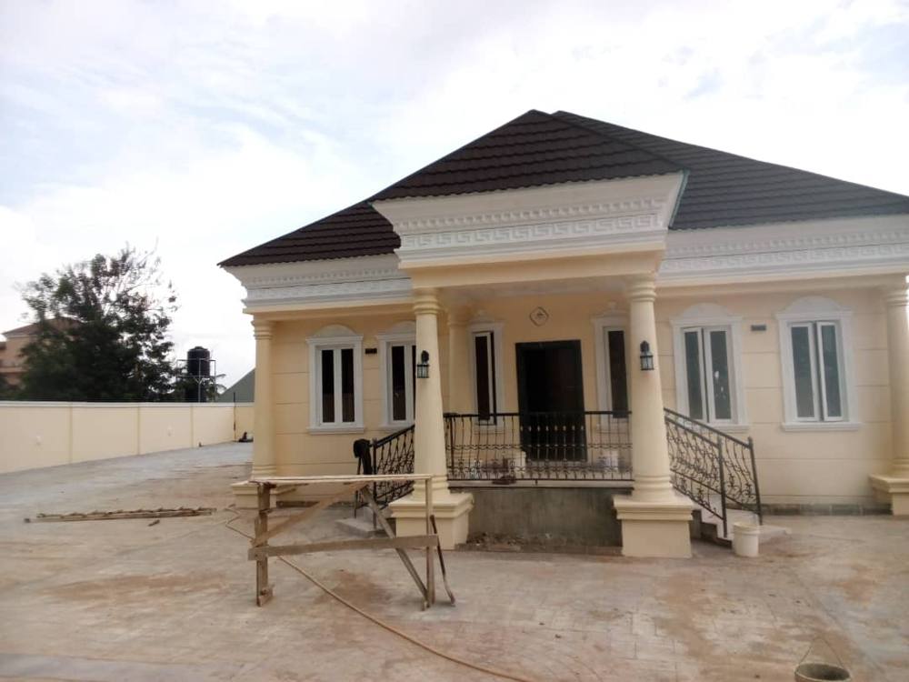 Finished cream bungalow with columns and iron railings