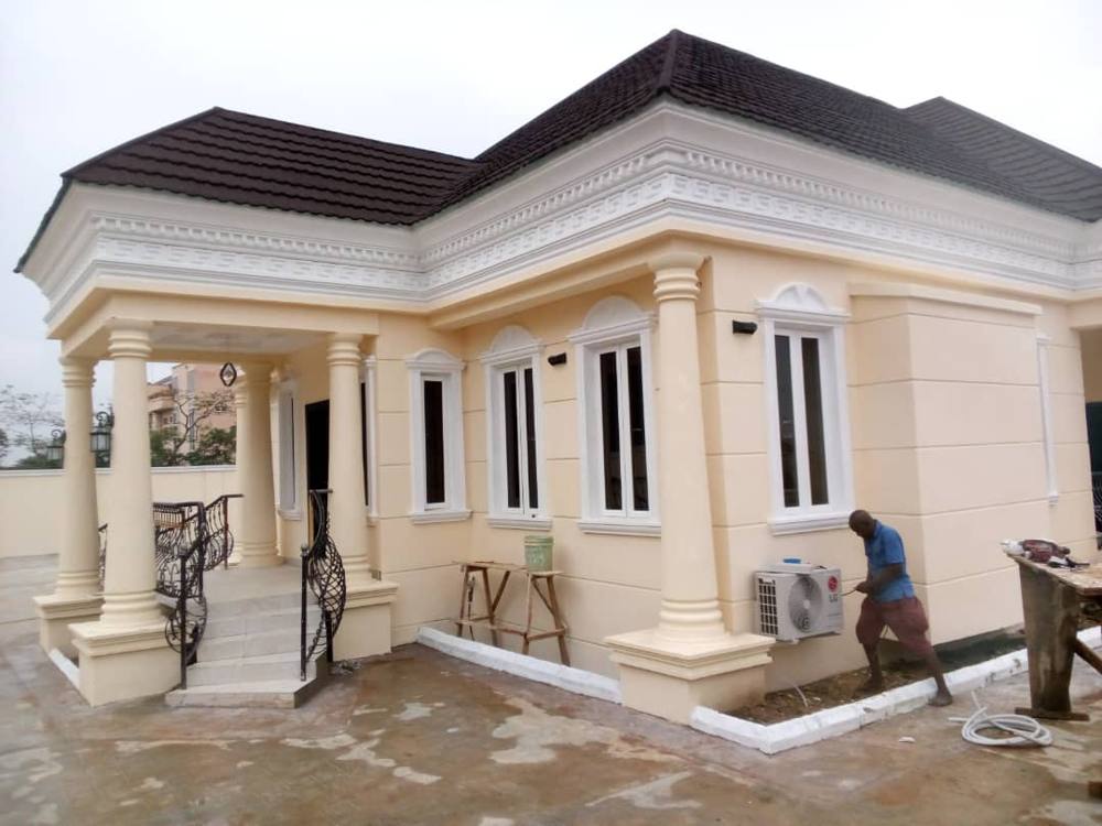 Cream bungalow with decorative cornice and arched windows