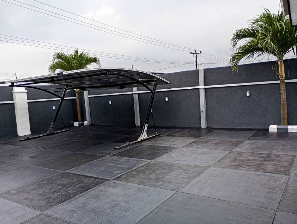 Carport on textured stamped concrete with palms