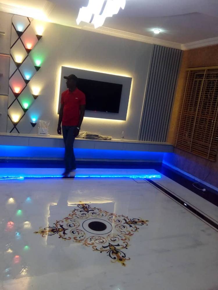 Living room with 3D epoxy floor medallion and LED wall