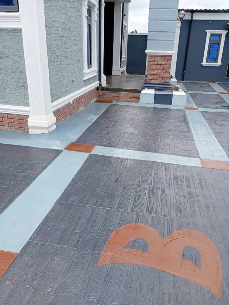 Close-up of stamped concrete with a logo inlay