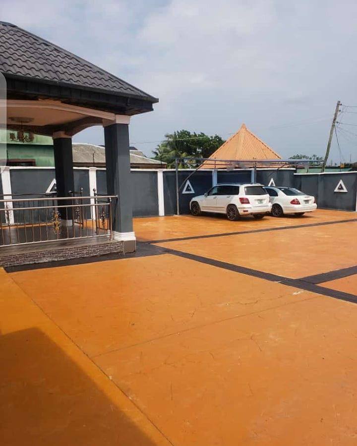 Orange stamped concrete compound with black borders