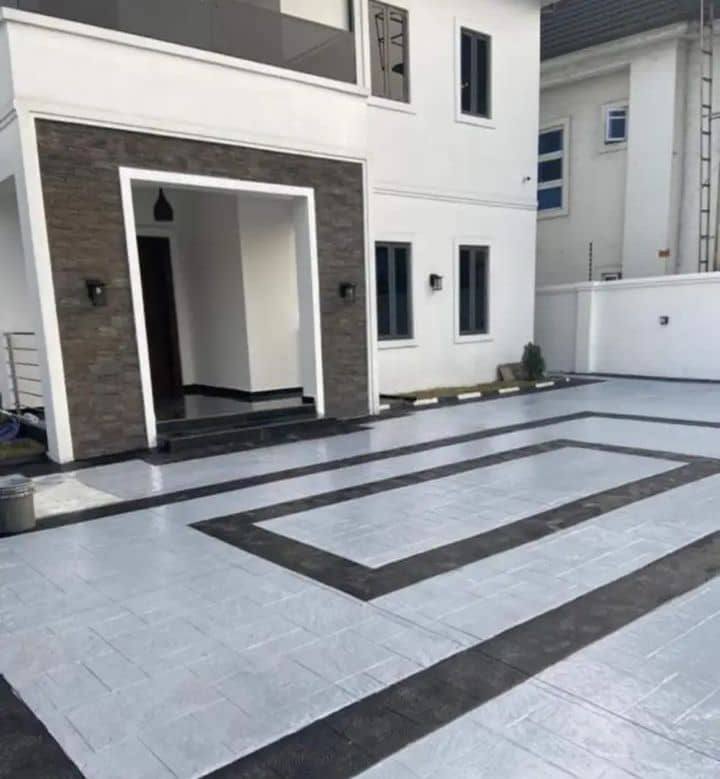 Light grey stamped driveway with black border pattern